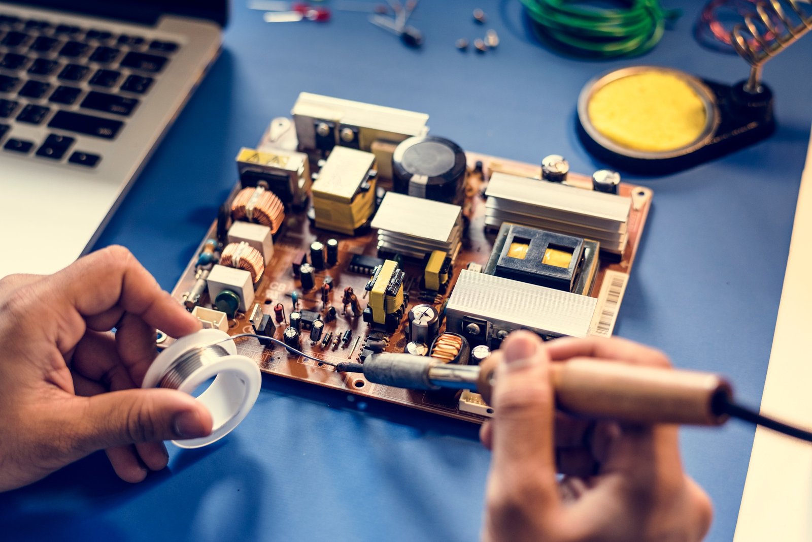Closeup of tin soldering with electronics circuit board